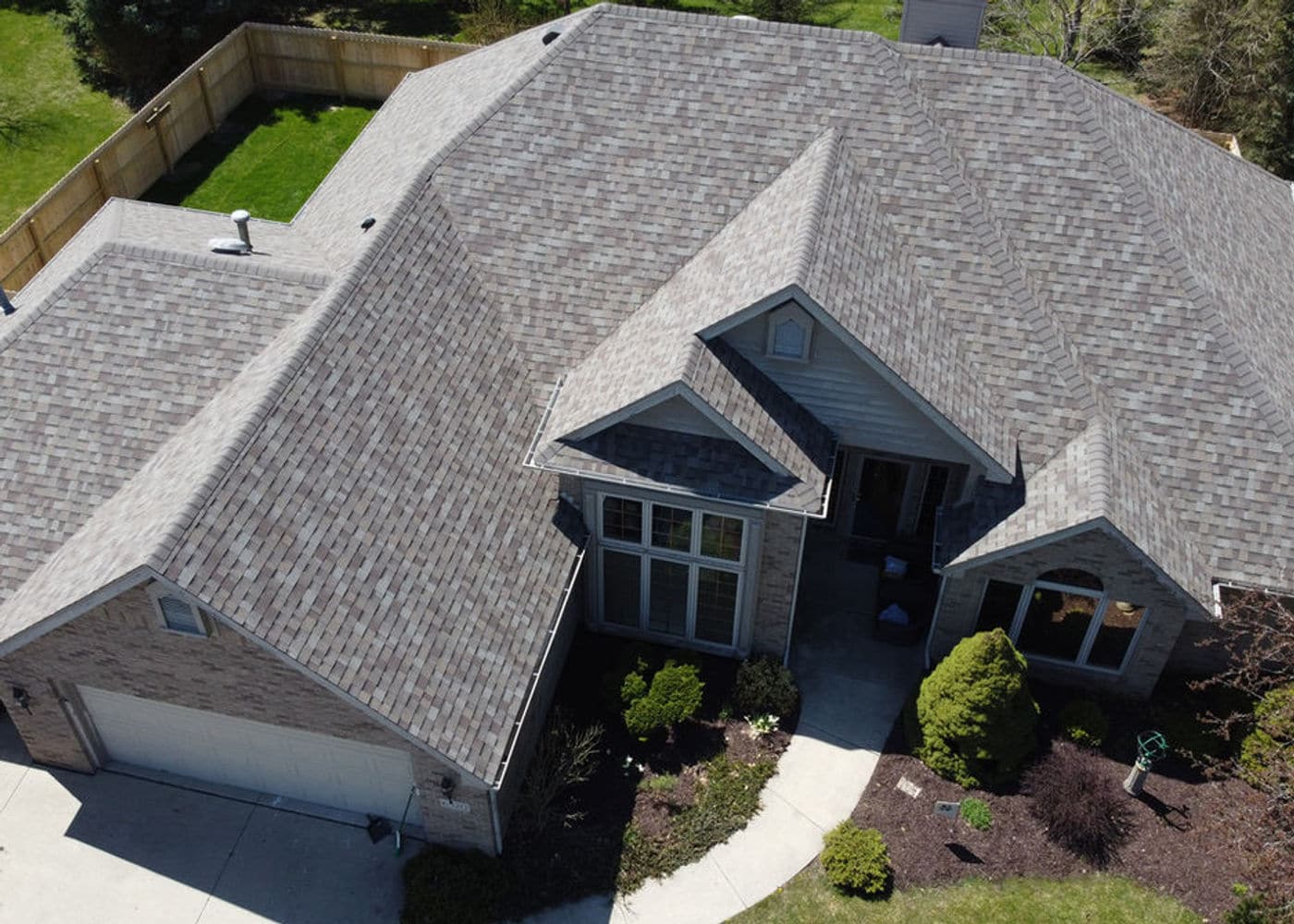 Gray shingle hip roof with skylights above an attached garage